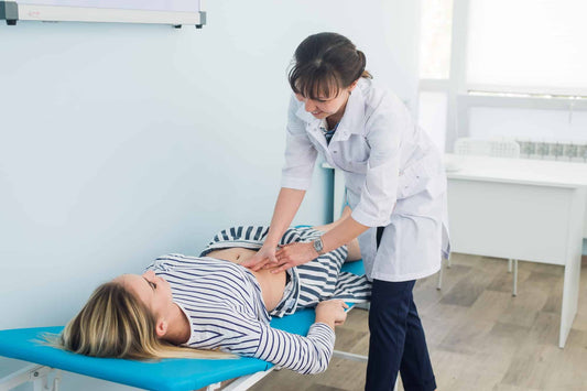 A woman consulting her doctor regarding a prenatal massage.