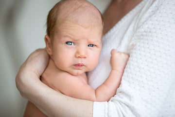 baby resting in his mother's arms